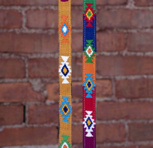 2 different God's Eye colorways in front of a brick background