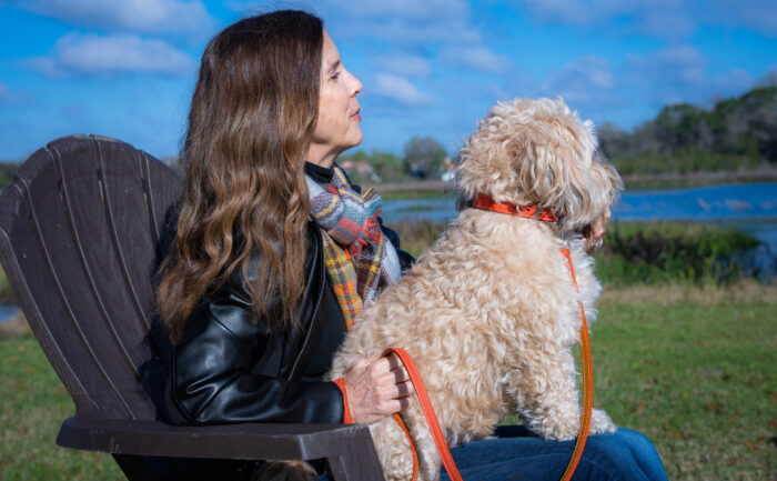 white dog wearing orange Tuscan Collar and Leash